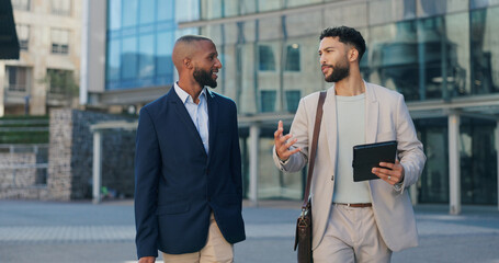 Business men, tablet and talking in city on commute to work in metro with discussion, chat and...