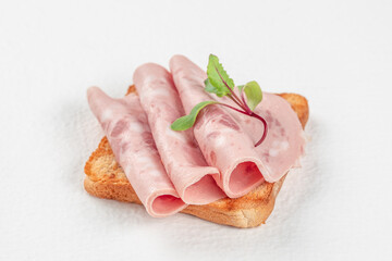 Delicious sandwich with sausage slices on white background