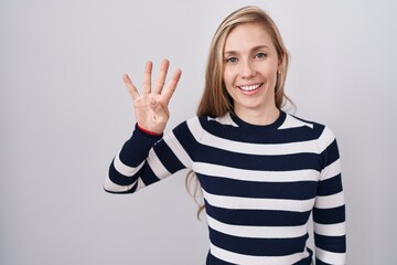 Young caucasian woman wearing casual navy sweater showing and pointing up with fingers number four...