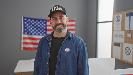 Portrait of a smiling bearded man with a 'voted' sticker, wearing a usa hat in front of the...