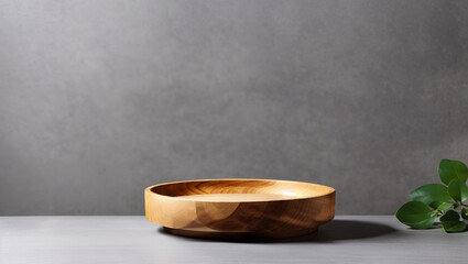 A wooden bowl sits on a concrete surface