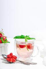 Strawberry tea concept. Good morning concept. Teapot, ripe fruits, healthy beverage