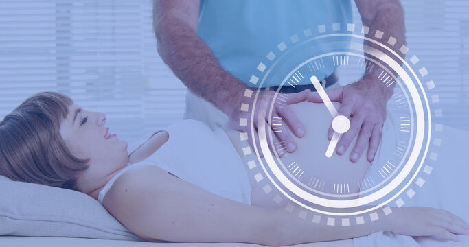 Fast moving clock over happy pregnant caucasian woman having belly massaged by husband