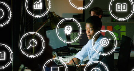 Image of digital icons with data processing over african american businesswoman in office