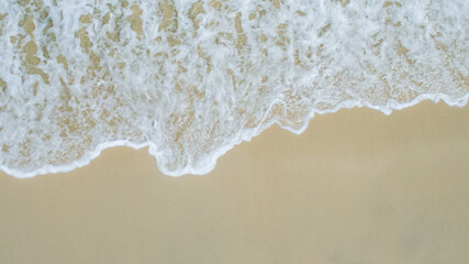 Soft wave of blue ocean on sandy beach. aerial view