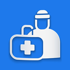 Paper cut First aid kit icon isolated on blue background. Medical box with cross. Medical equipment for emergency. Healthcare concept. Paper art style. Vector