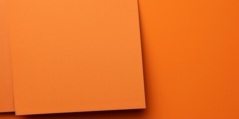 Orange background with dark orange paper on the right side, minimalistic background, copy space concept, top view, flat lay