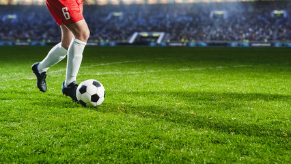 Close-Up On Legs Of Professional Football Player Dribbling With A Ball During International Soccer Championship On National Arena. Athlete Running To Score A Winning Goal In Final Match On Big Stadium