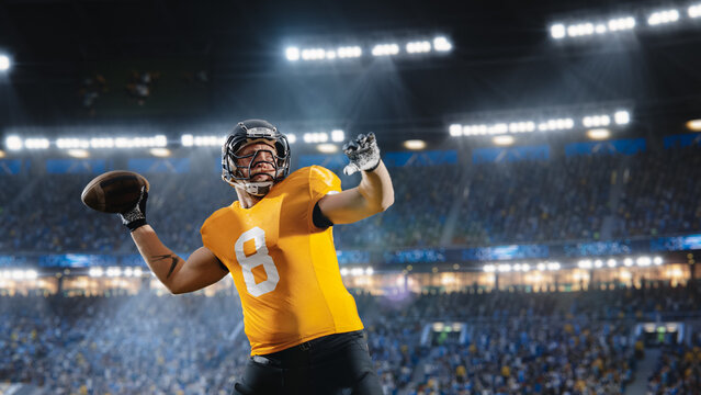 Aesthetic Shot of American Football Player Throwing a Ball on Big Stadium With Crowd Cheering. International Championship Match on Arena Full Of Fans. Photo Of Successful Pass Of Professional Athlete.