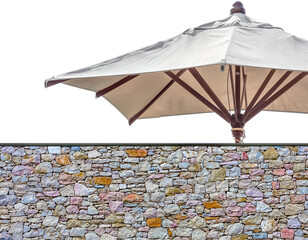 Parasol de jardin derrière mur de pierres