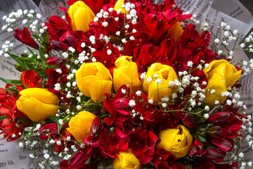 Bouquet of yellow and red flowers. Bouquet with yellow tulips