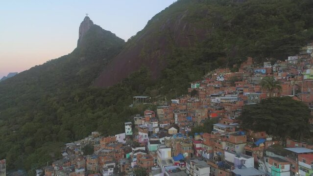 Aerial of hillside favela beneath Christ the Redeemer in Rio de Janeiro, Brazil