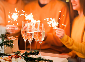 Glasses of champagne on table with blurred background of festive lights and sparkles