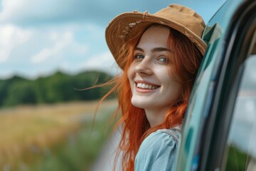 Happy woman enjoying a car journey on a summer road trip