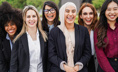 Multiethnic business women colleagues smiling on camera outdoor - Diversity and female expertise concept - Main focus on arabian girl face