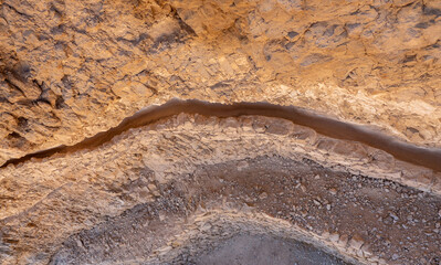 Ancient water drain in the rock. Masada fortress. Dead Sea, Jordan.