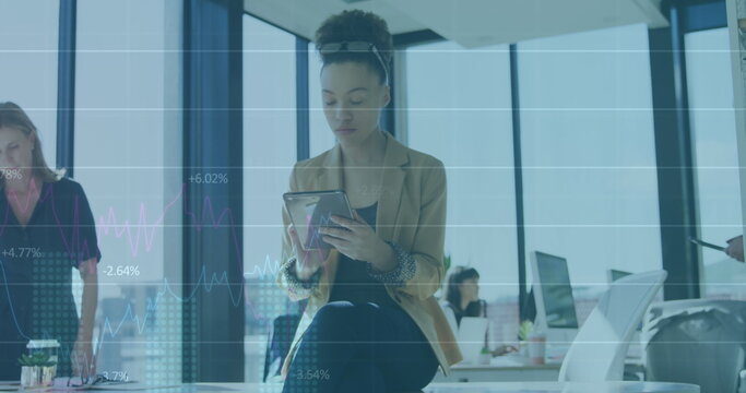 Image of data processing over biracial businesswoman using tablet - Powered by Adobe