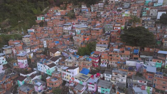 Wide aerial of densely packed colourful favela houses on hillside in Rio de Janeiro, Brazil
