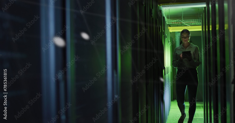 Poster data processing against caucasian female engineer with digital tablet working in server room