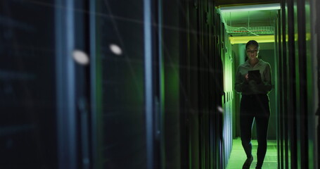 Data processing against caucasian female engineer with digital tablet working in server room