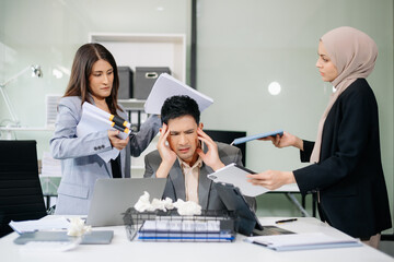 Furious Asian businesspeople arguing strongly after making a mistake at work in office