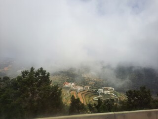 Fototapeta premium Mesmerizing natural beauty of Abha in Saudi Arabia in the summer season. High mountains, greenery, low clouds and fog are the beauty of Abha.