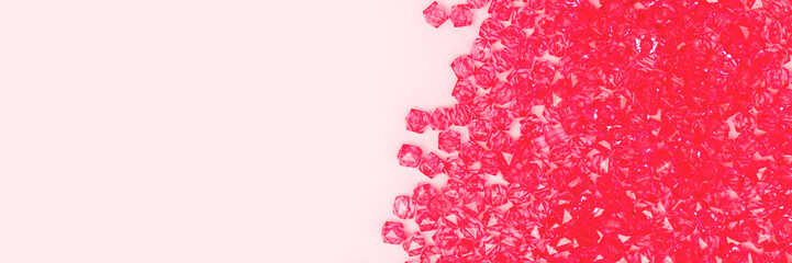 Banner with beads scattered on a pink background with copy space.