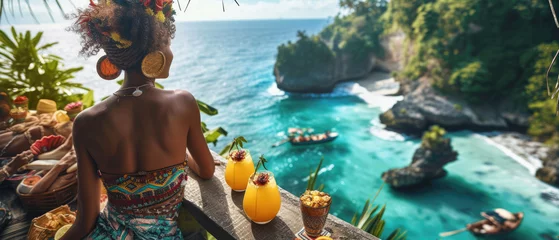 Deurstickers Woman on the background of a tropical bay from a cliff with refreshing drinks © Александр Марченко