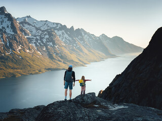 Father and daughter hiking together in northern Norway family vacations active healthy lifestyle adventure outdoor dad with child enjoying mountains and fjord of Kvaloya island
