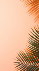 Fototapeta na wymiar Palm leaf on a peach background with copy space for text or design. A flat lay, top view. A summer vacation concept