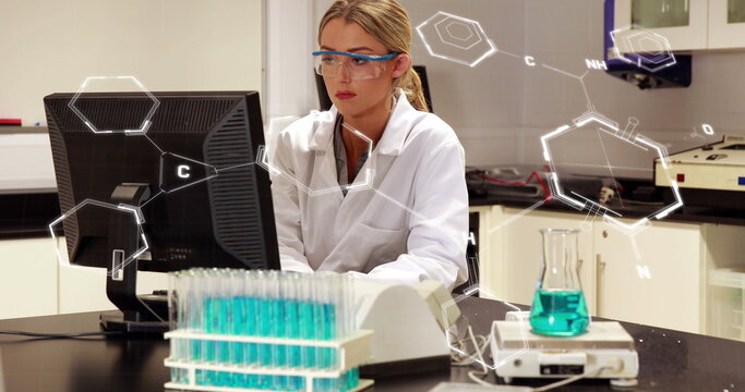 Image of chemical formulas over caucasian female lab worker using computer - Powered by Adobe