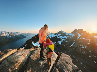 Mother and daughter hiking in mountains travel vacations in Norway outdoor activity adventure healthy lifestyle, parent and child on the summit together, Mothers day holiday - 785377659