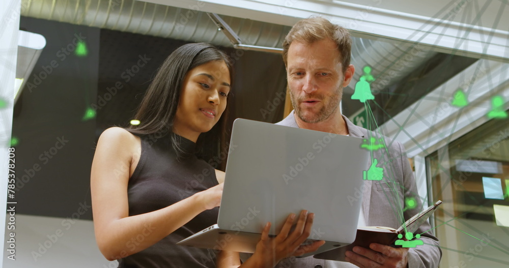 Poster image of connected computer icons forming globe over diverse coworkers analyzing data on laptop