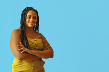 portrait of young adult beautiful african american woman with braid hair arms crossed posing at studio looking at camera