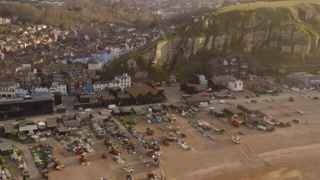 Birds eye view fishing coastal Hastings town buildings panorama.Beach with boats and west cliff Funicular. British architecture and culture in east of Sussex, south coast 