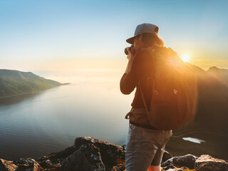 Photographer with camera taking photo outdoor freelancer content creator traveling with backpack ...