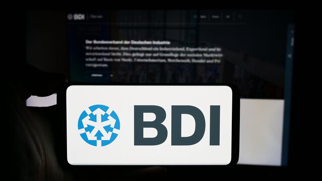 Stuttgart, Germany - 04-07-2024: Person holding cellphone with logo of Bundesverband der Deutschen Industrie e.V. (BDI) in front of webpage. Focus on phone display.