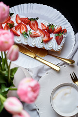 sponge roll with cream, decorated with fresh strawberries
