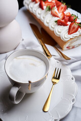 sponge roll with cream, decorated with fresh strawberries