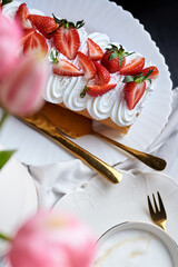 sponge roll with cream, decorated with fresh strawberries