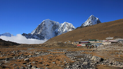 Small settlement Lobuche and snow covered mountains Tobuche, Taboche and Cholatse, Nepal.