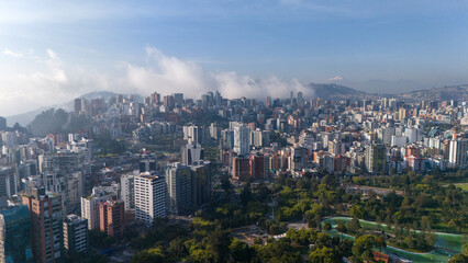 Aerial drone view of Quito capital city of Ecuador South America Parque La Carolina Sunrise early...