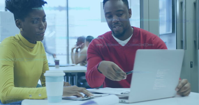 Image of statistics and data processing over business people using laptop