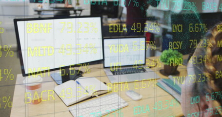 Composite of financial data processing over businesswoman using computer in office