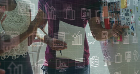 Image of financial data processing and icons over diverse business people working at office