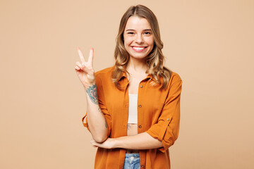 Young smiling happy cheerful Caucasian woman she wear orange shirt casual clothes look camera...