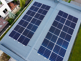 Obraz premium Solar panels on pitched metal roof. Home Renewable Energy Systems. Solar Rooftop System. Photovoltaic Roofing