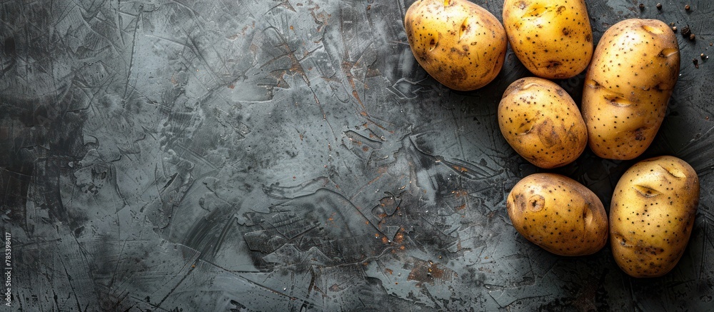Poster a stack of potatoes neatly arranged on top of a table.