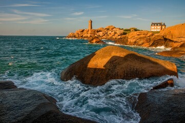 Lighthouse of Ploumanach at the golden hour in Perros-Guirec, Côtes d'Armor, Brittany, France. Sea...