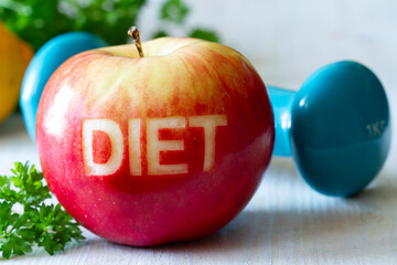 Red apple with cut-out word diet and dumbbell, diet and healthy lifestyle concept